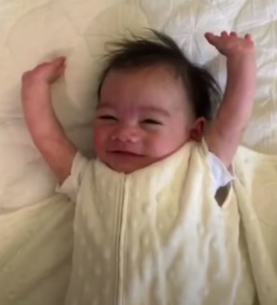 Tiny baby throws arms up after being unswaddled and it's too sweet